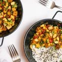 Kung Pao Tofu with celery, red peppers, and peanuts in a dish with white rice.