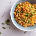 Slow cooker sweet and sour chickpeas with pineapple, red pepper, and cilantro in a bowl.