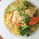 Slow cooker chicken curry with vegetables in a coconut milk broth in a bowl.