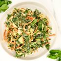 Asian slaw with kale, apples, and carrots with fresh basil and mint on the side.