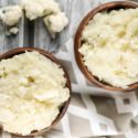 Mashed cauliflower served in two small wooden bowls.