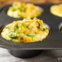 Broccoli cheddar quinoa egg muffins with cooked broccoli, cooked quinoa, and eggs cooked in a muffin tin. 