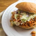 Buffalo chicken sloppy joes with ranch coleslaw in a hamburger roll.