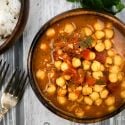 Easy chana masala recipe with a bowl of basmati rice and a fork.