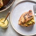 Stuffed chicken breasts with broccoli and cheddar on a plate with mustard on the side.