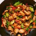 Chicken stir fry with chicken breast, broccoli, carrots, bell peppers, and onions in a homemade stir fry sauce.