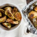 Crispy balsamic brussels sprouts with olive oil, garlic, salt, and pepper in a bowl. 