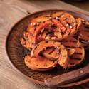 Grilled acorn squash on a plate with caramelized edges. 