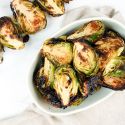 Grilled Brussel Sprouts on a skewer and in a bowl with grill marks.