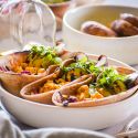 Veggie tacos tacos with mushrooms, corn, and zucchini in a wheat taco shell in a bowl. 