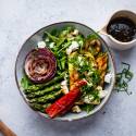 Grilled vegetabe salad with zucchini, asparagus, mushrooms, peppers, onions, and feta cheese served over arugula.