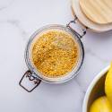 Homemade lemon pepper seasoning with dried lemon zest, black pepper, kosher salt, garlic powder, and onion powder in a glass jar.