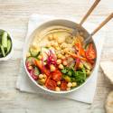 Hummus bowls with creamy hummus, quinoa, chickpeas, cucumbers, arugula, and red onions.