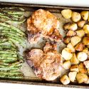 Sheet Pan Pork Chops with potatoes and green beans on a sheet pan.