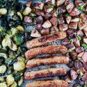 Sheet pan sausage with potatoes and Brussels sprouts on a sheet pan. 