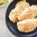 Cooked Parmesan crusted Tilapia fish on a round plate