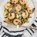 Pesto shrimp and zucchini noodles with Parmesan cheese and lemon,