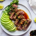 Sesame crusted tuna sliced and cooked rare served with soy dipping sauce and avocado.