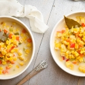 Slow cooker corn chowder with red peppers, carrots, celery, and poblano peppers in a creamy broth.