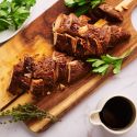 Slow cooker turkey breast tenderloin sliced on a wooden cutting board.