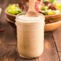 Southwest salad dressing in a glass jar with Greek yogurt, lime juice, taco seasoning, and salsa.