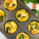 Sweet potato spinach egg muffin frittatas in a muffin tin with eggs, egg whites, spinach, and sweet potatoes.