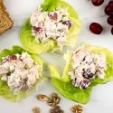 Waldorf chicken salad wrapped in lettuce with grapes, walnuts, and whole wheat bread.