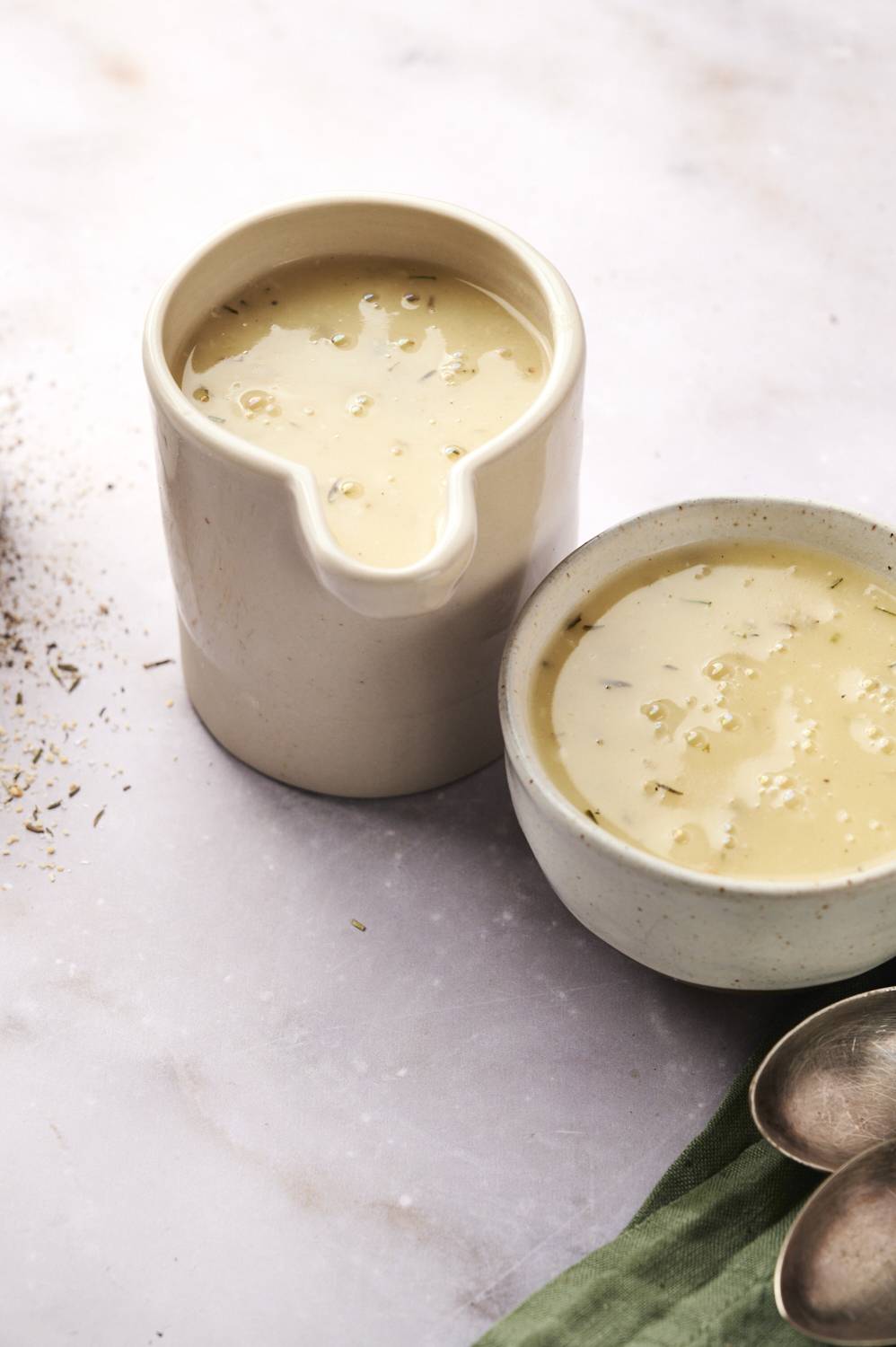 Two bowls of graving sitting together on a counter.