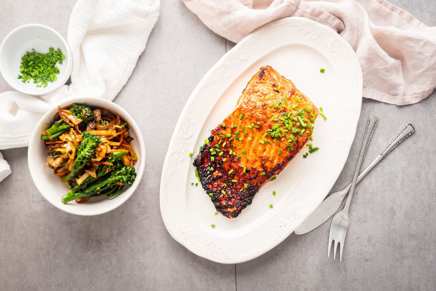 Baked brown sugar salmon with a crispy crust and stir fried vegetables on the side.