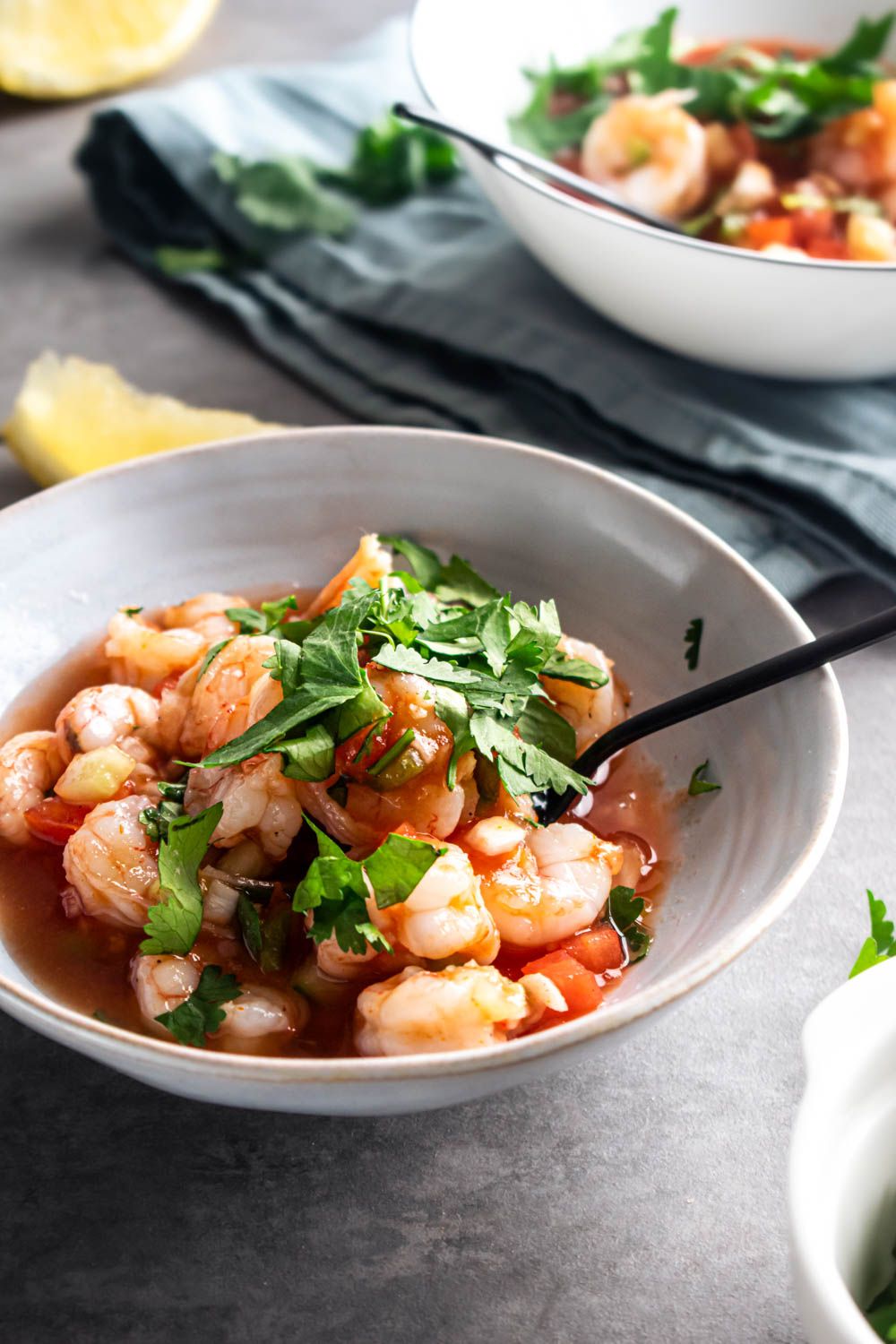 Mexican coctel de camarones with shrimp tossed in tomato sauce with cilantro, cucumbers, and onions.