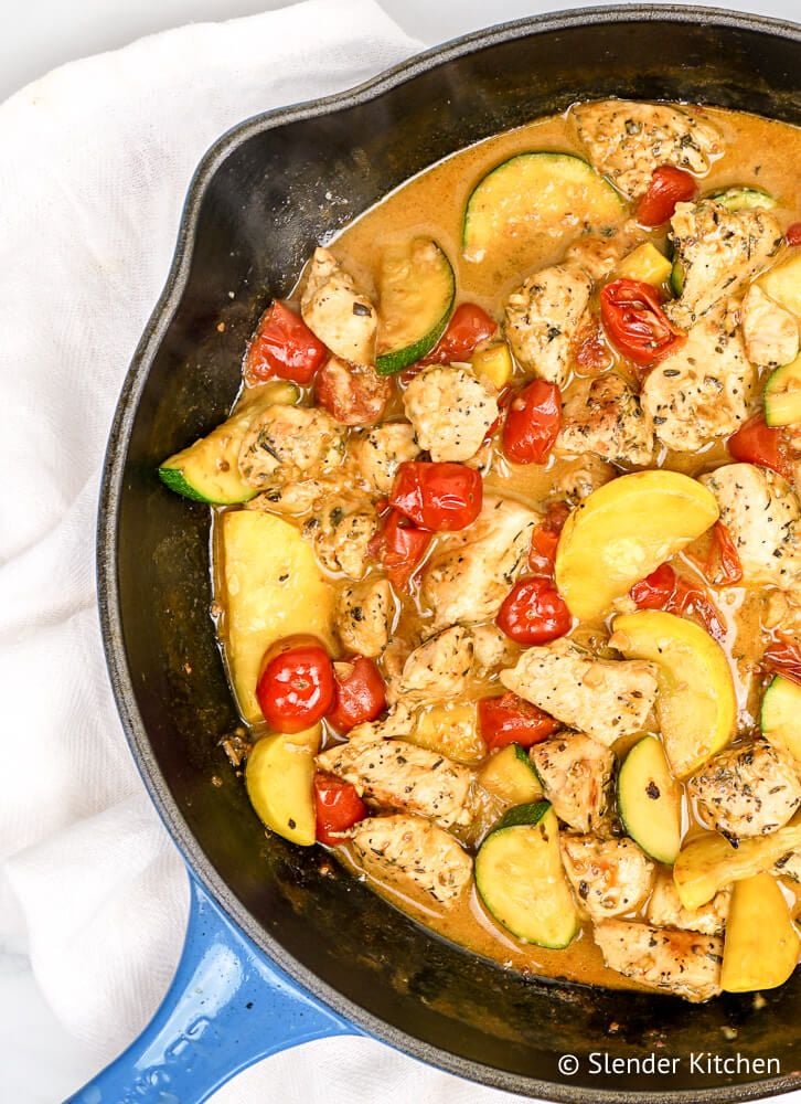 Healthy Tuscan Chicken in a creamy sauce with tomatoes and zucchini.