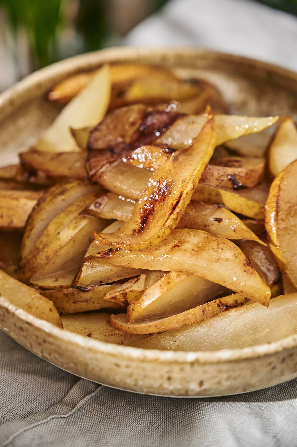 Cinnamon grilled pears in a bowl with browned edges. 