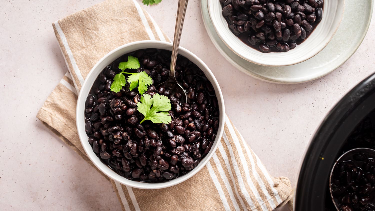 Crockpot black beans served in a bowl with cilantro.