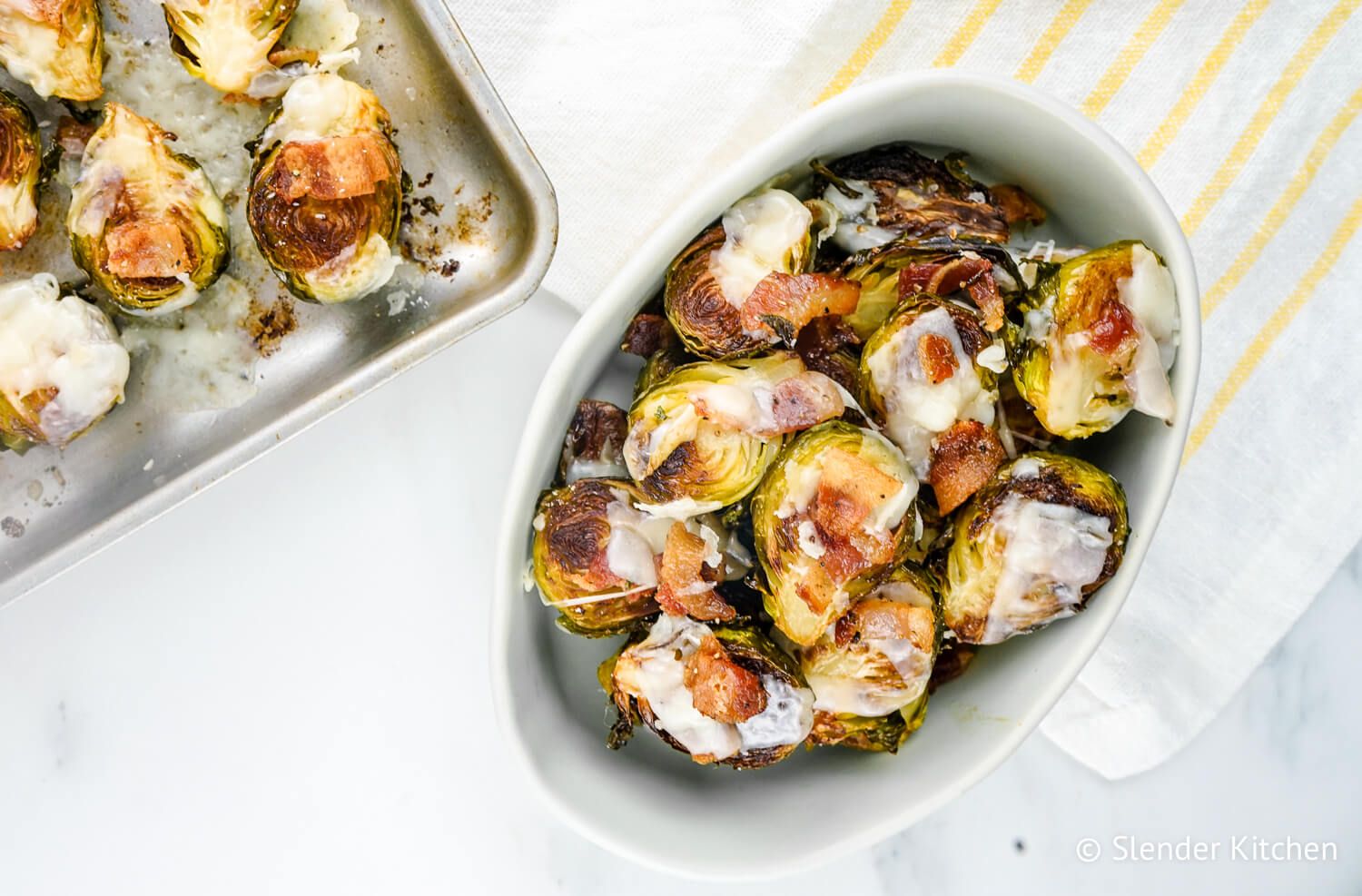 Garlic Bacon Brussels sprouts with Parmesan cheese on a sheet pan.