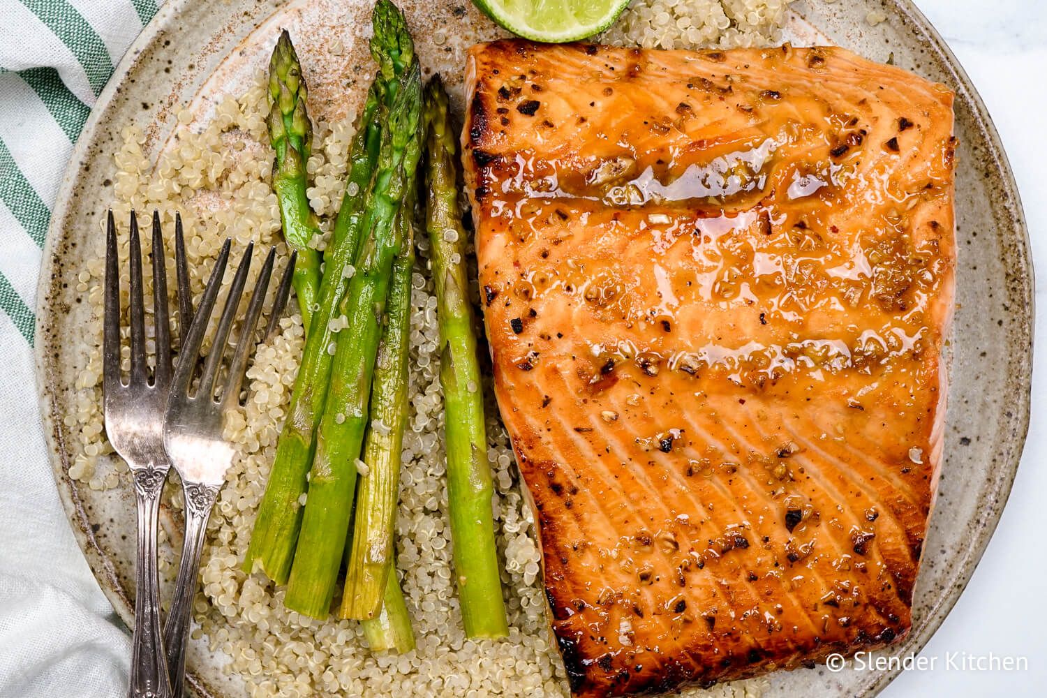 Honey garlic broiled salmon with caramelized edges served with asparagus and quinoa.