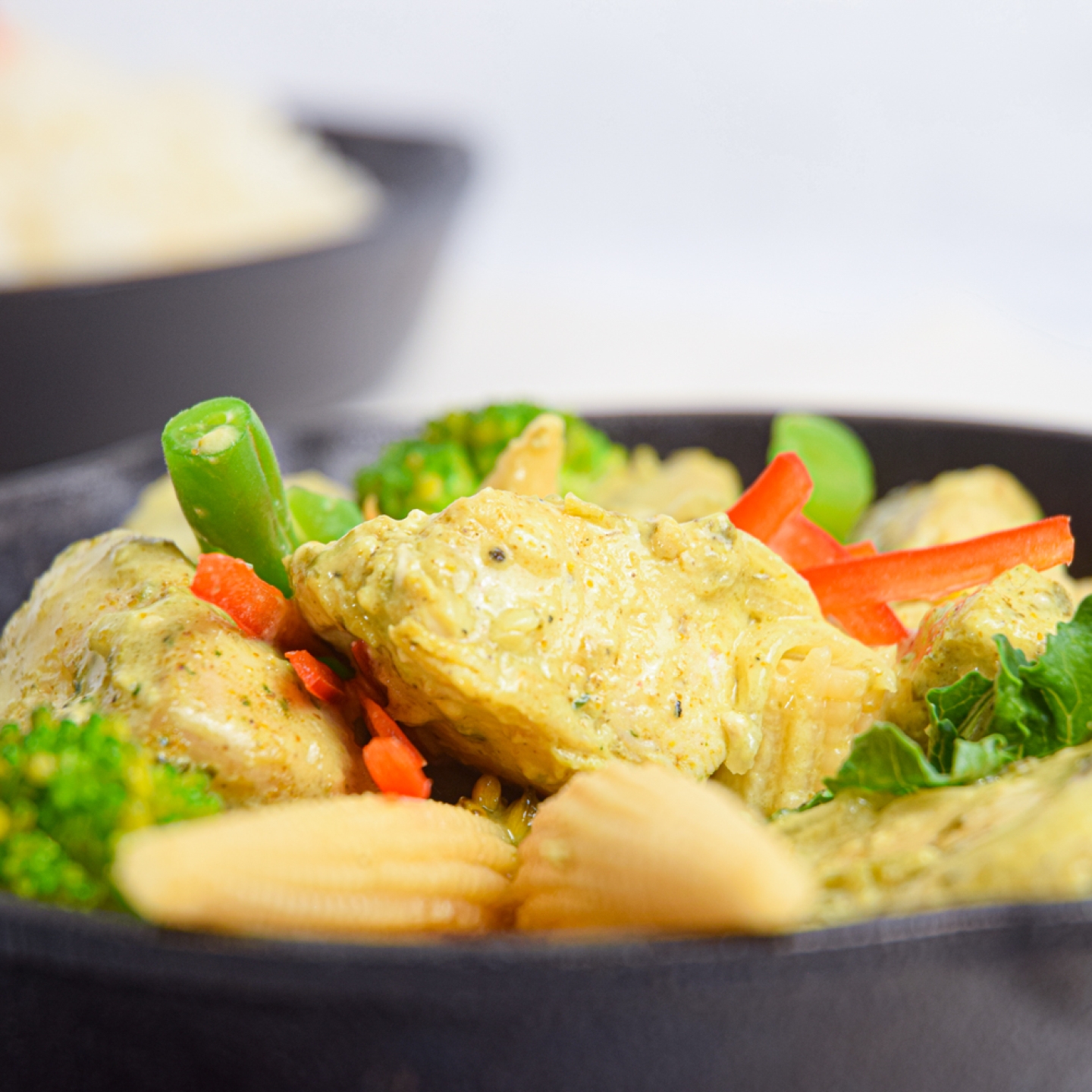 Slow Cooker Thai Curry Chicken with vegetables and curry sauce in a bowl with rice.