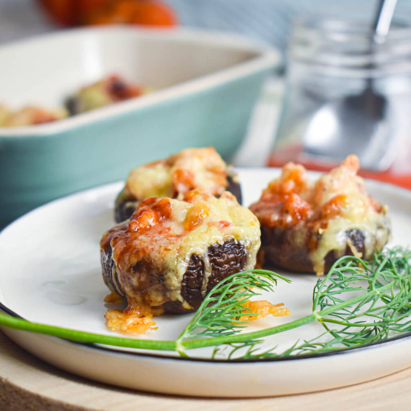 Mexican stuffed mushrooms with ground turkey, veggies, and enchilada sauce.