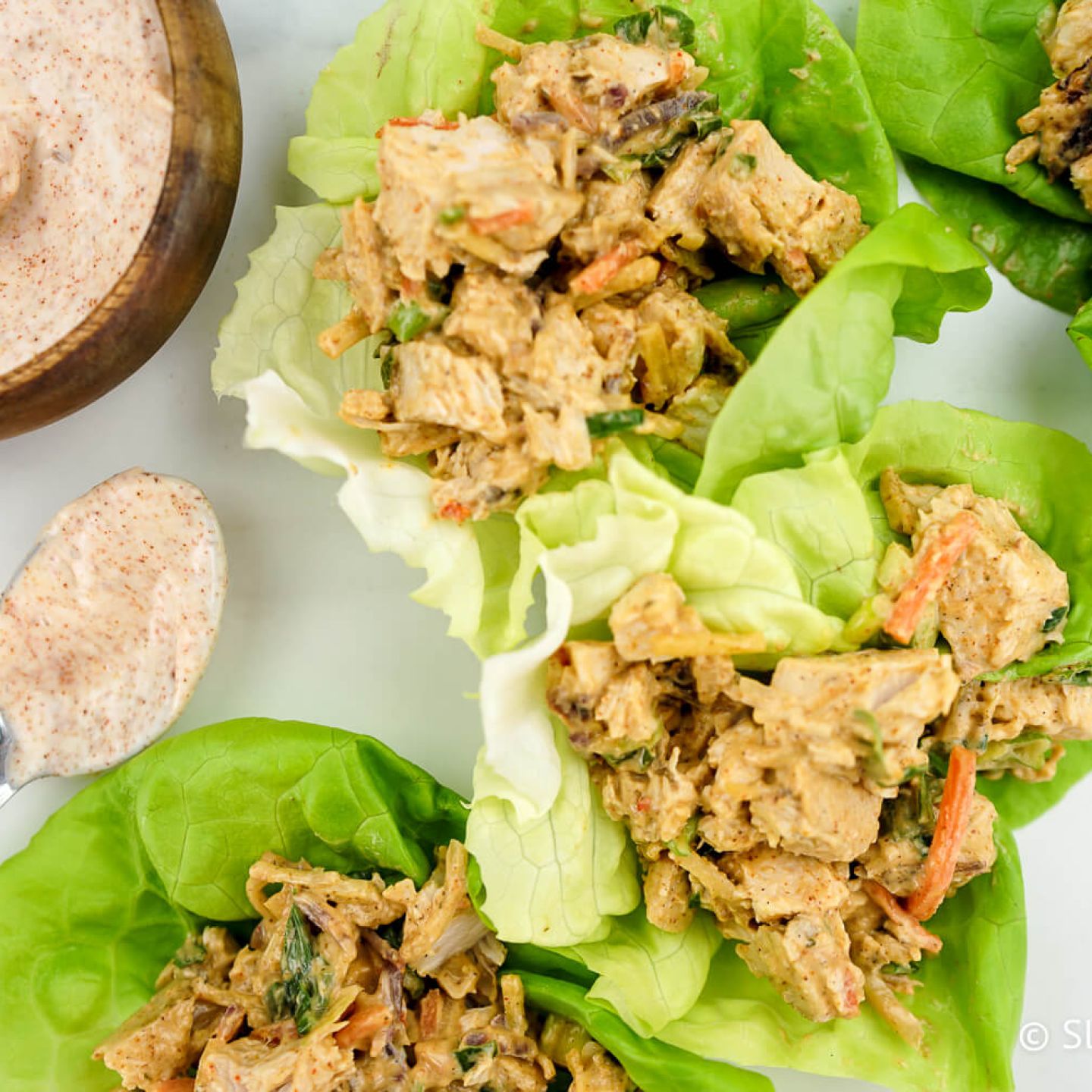 Blackened chicken salad served in lettuce wraps.