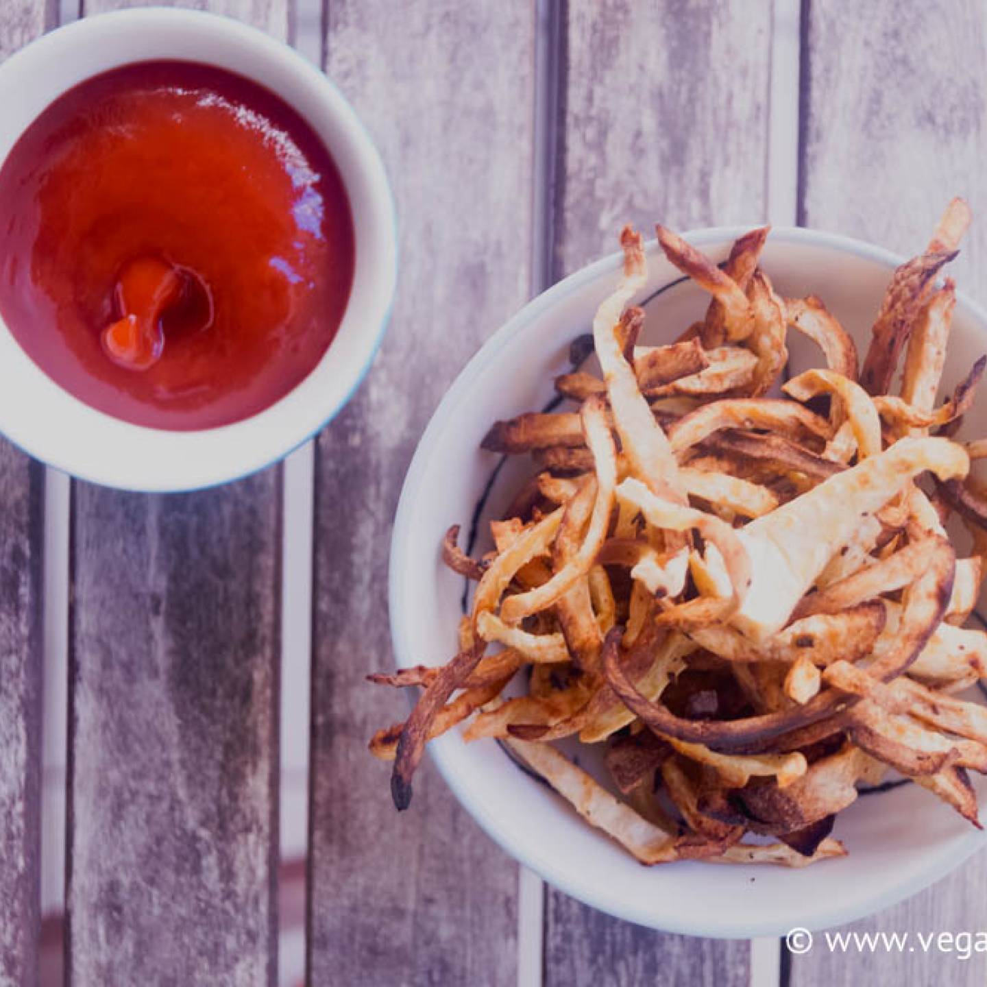 Celeriac fries baked until crisp and golden brown served in a bowl.