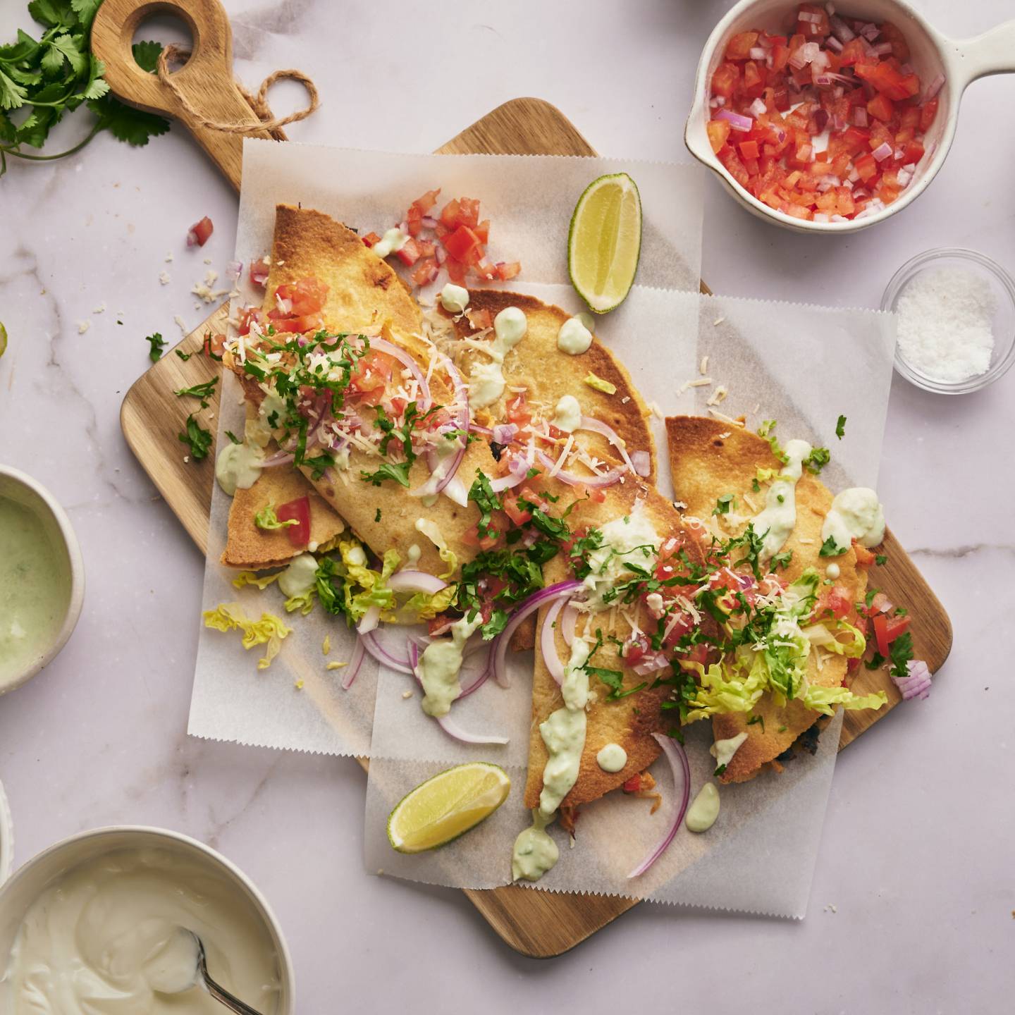 Crispy chicken tacos with corn tortillas stuffed with chicken and beans served with cilantro, salsa, and sour cream.