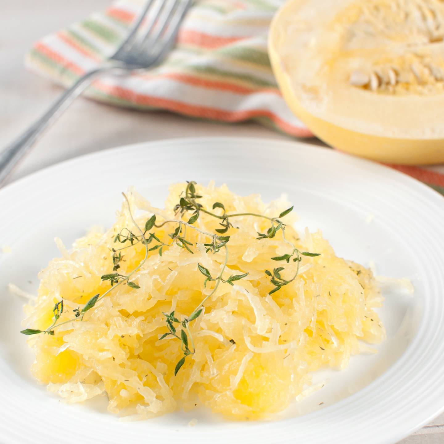 Garlic spaghetti squash on a plate with parsley.