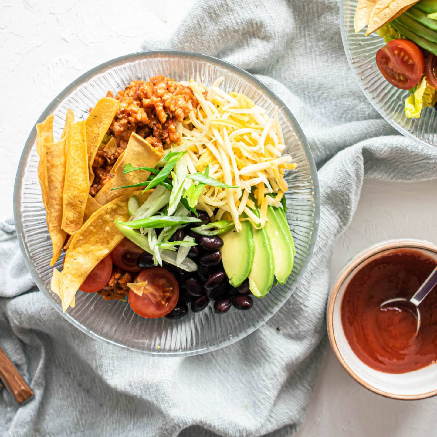 Turkey taco salad with ground turkey, tomatoes, black beans, cheddar cheese, and crispy tortilla strips.