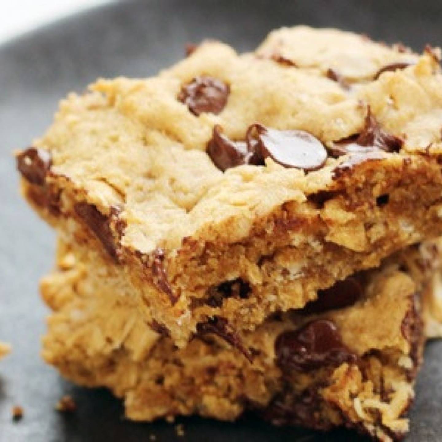 Peanut Butter chocolate chip oatmeal bars with whole grain oats on a plate.