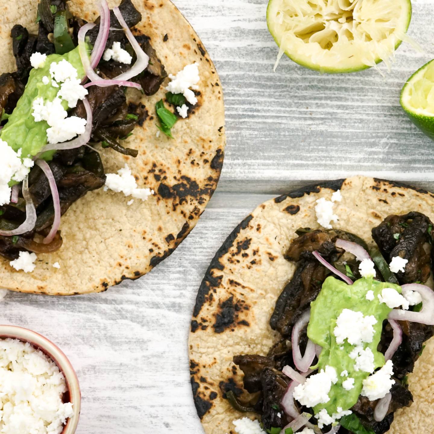 Portobello mushroom tacos with avocado salsa on corn tortillas.