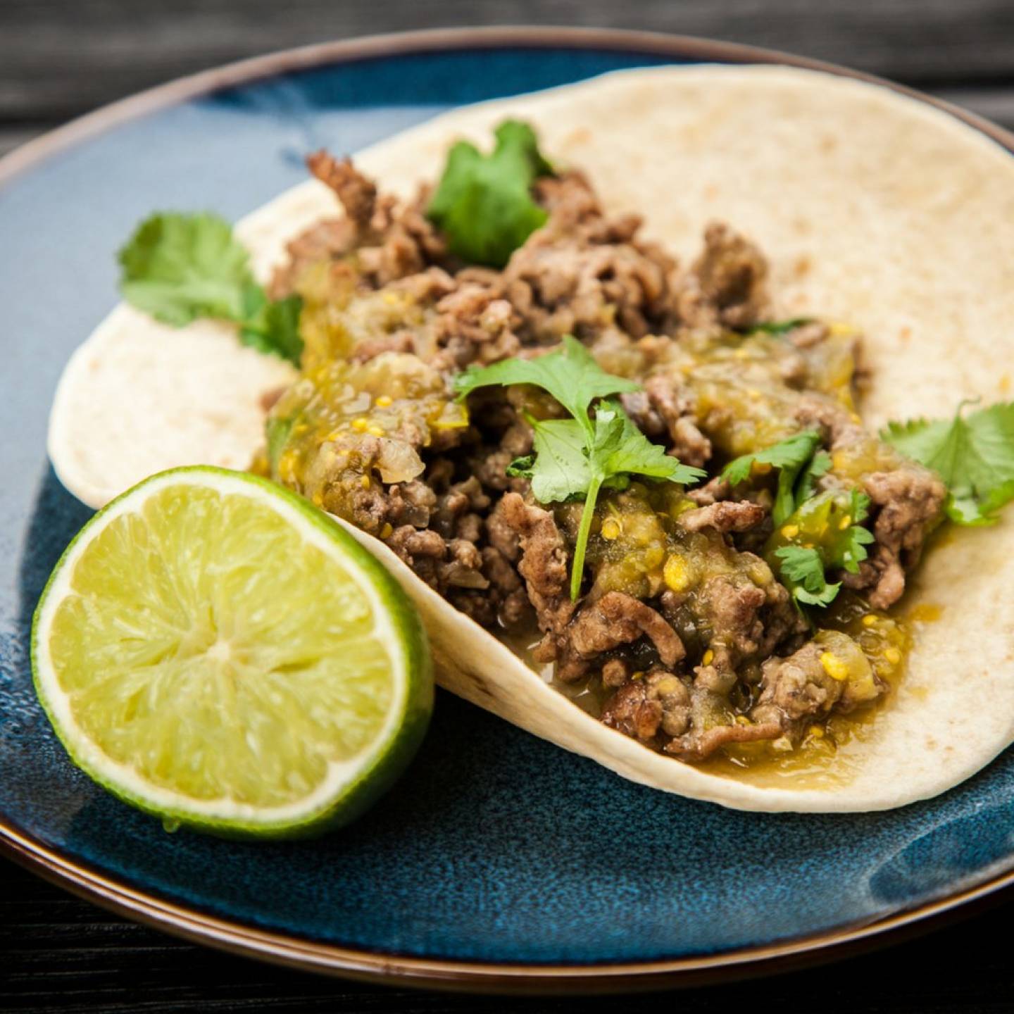 Ground turkey tacos with salsa verde in yellow corn tortillas.