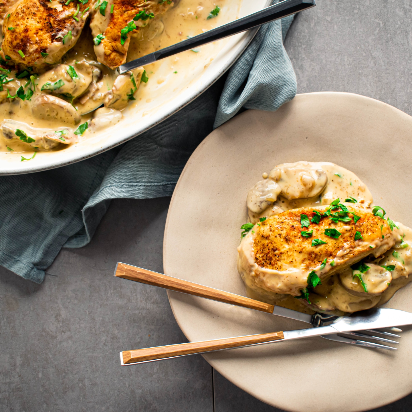 Slow cooker chicken marsala with chicken breast in a mushroom marsala sauce on a plate with parsley.