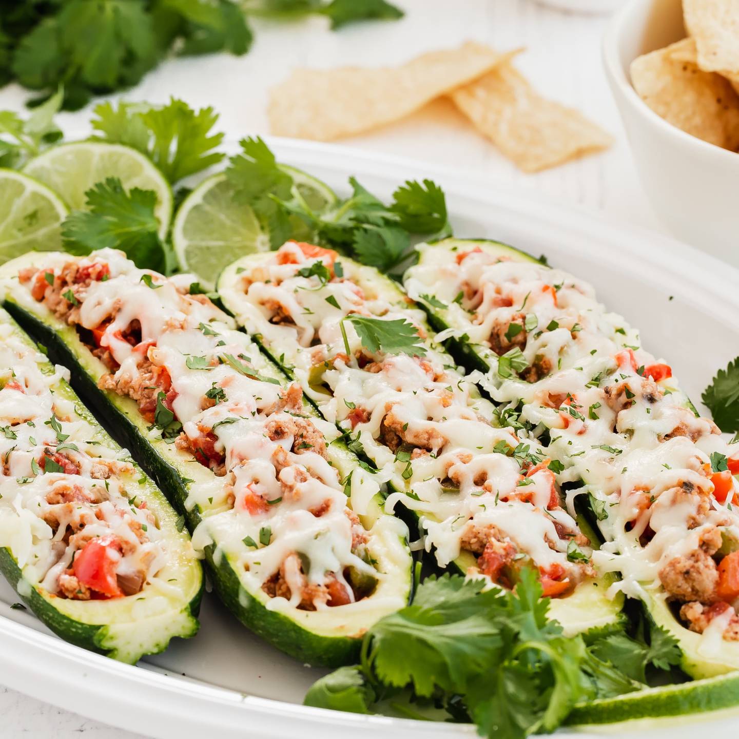 Zucchini taco boats with ground turkey, salsa, and melted cheese.