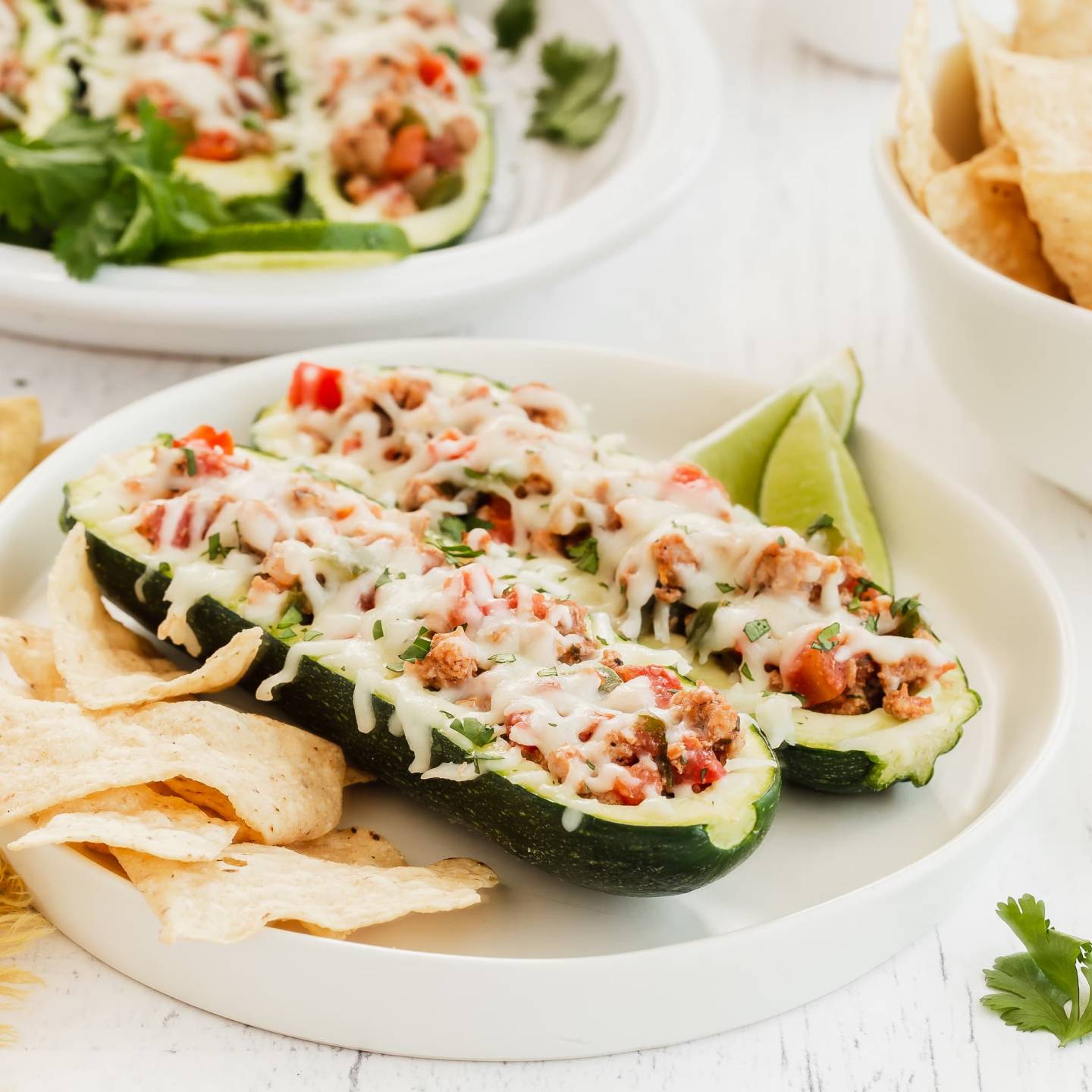 Turkey Fajita Zucchini Boats with ground turkey, pepper, onions, and tomatoes in hollowed out zucchini with melted cheese.