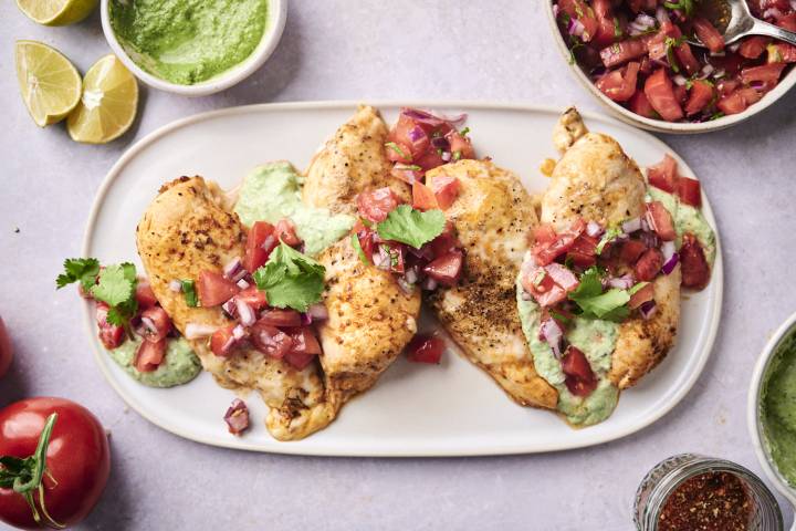 Fiesta lime chicken served on a plate with melted pepper jack cheese, pico de gallo, and creamy cilantro ranch dressing.