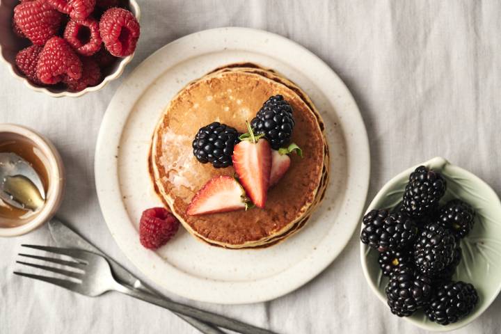 Fluffy protein pancakes topped with fresh berries.